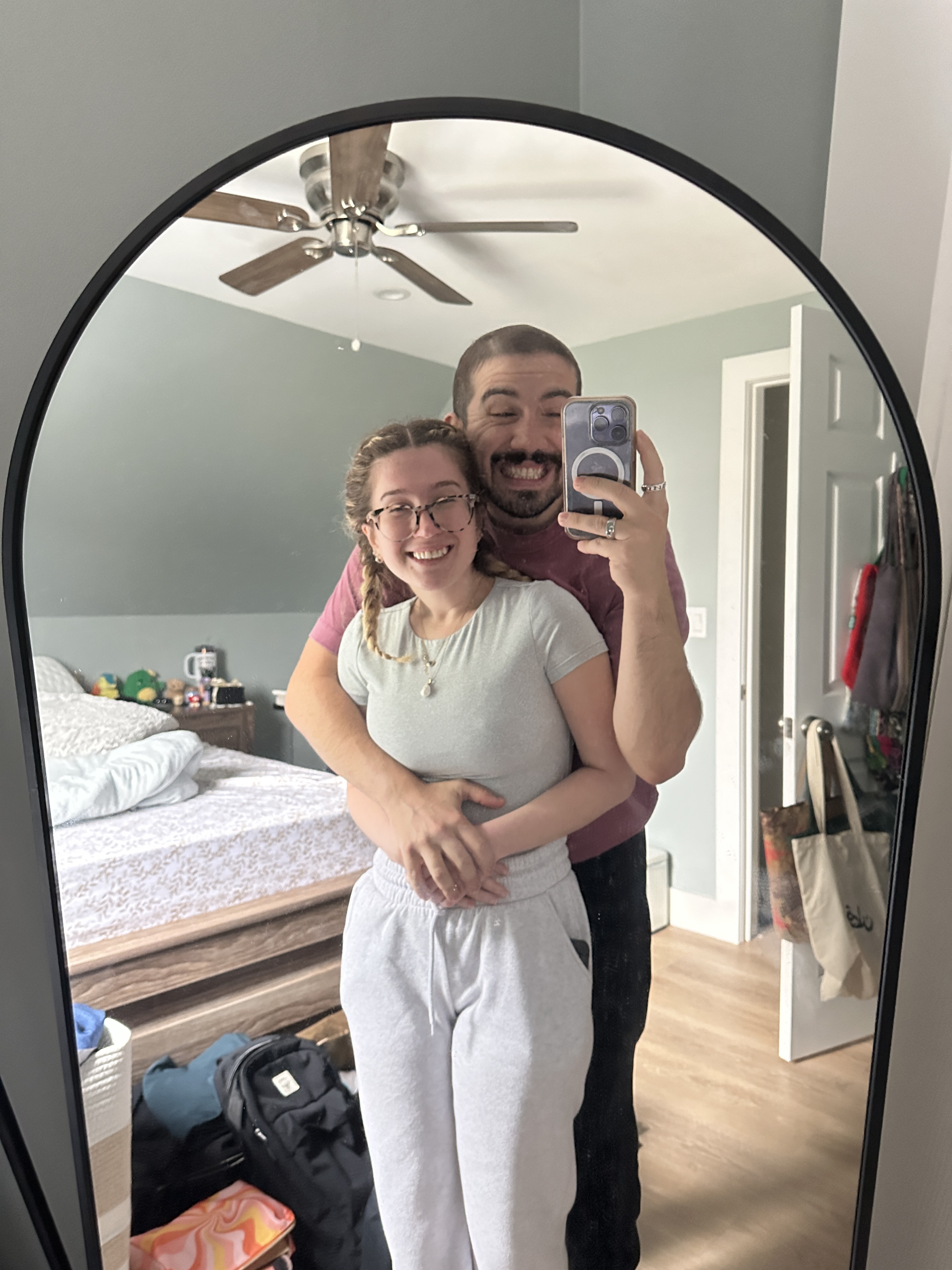 t and i posing in mirror with big cheese smiles